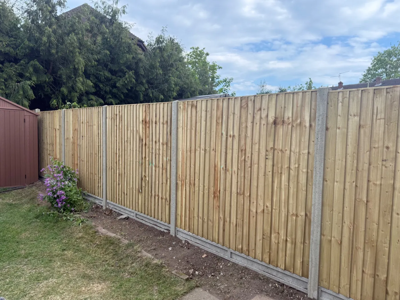 Long run of closeboard fence panels and gravel boards in a Farnham garden