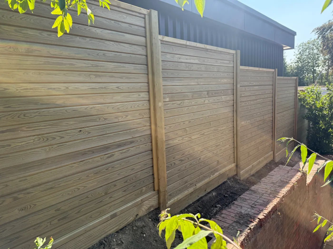 Horizontal tongue and groove fence panels installed in a Farnham garden
