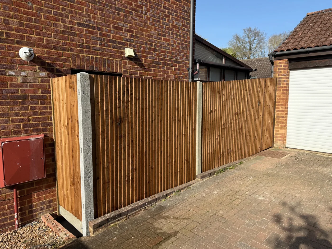 Closeboard fencing screening a driveway next to a garage in Farnham