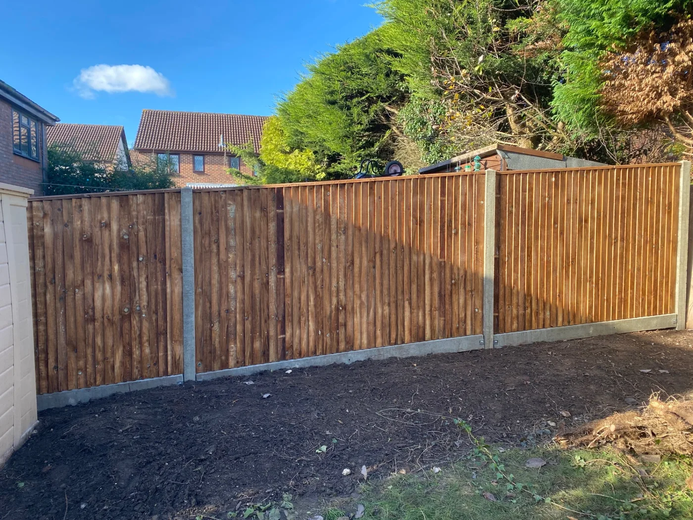 Closeboard feather edge fence panels with concrete posts in a Farnham garden
