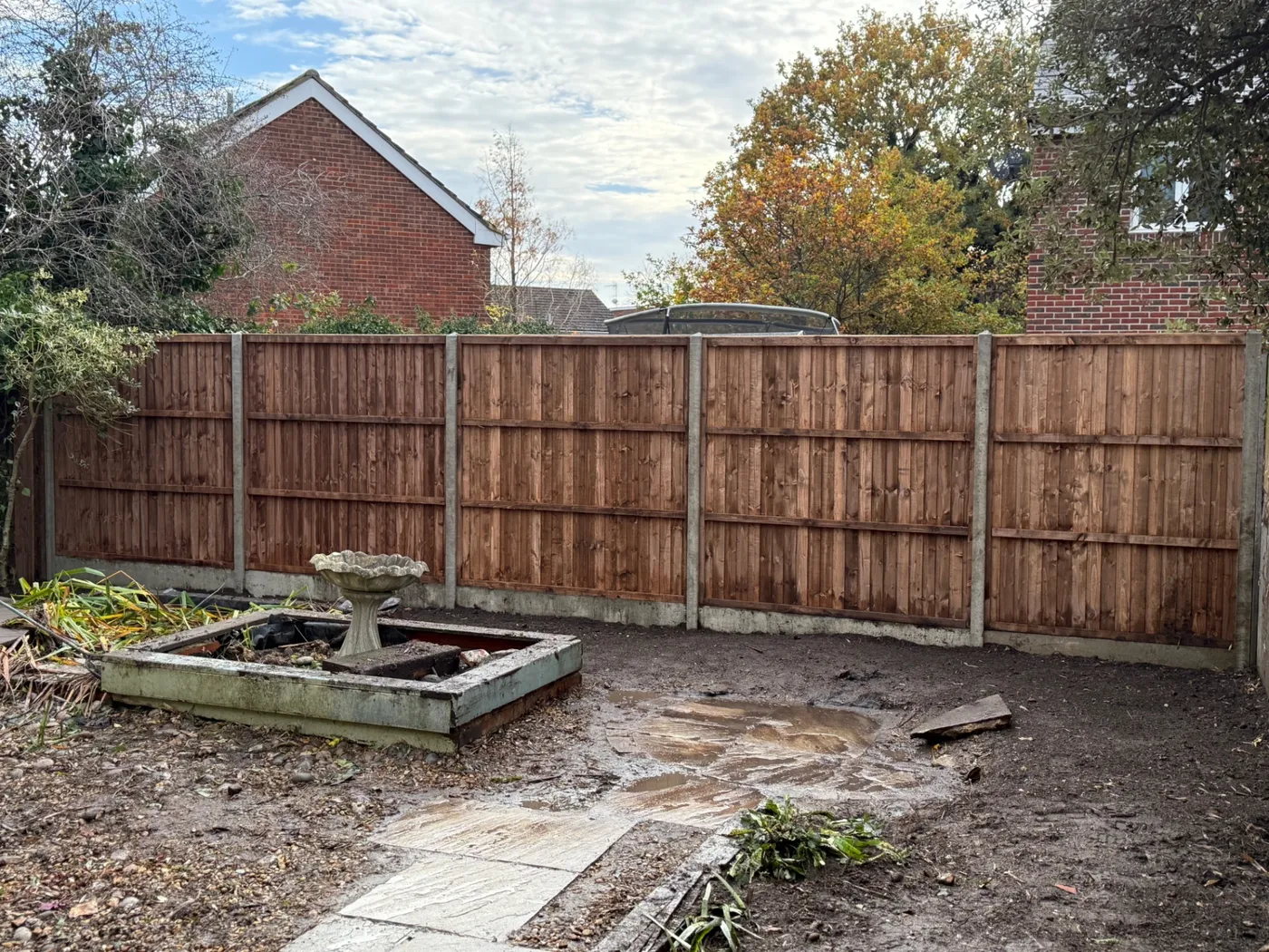 New feather edge fence line installed across a rear garden boundary