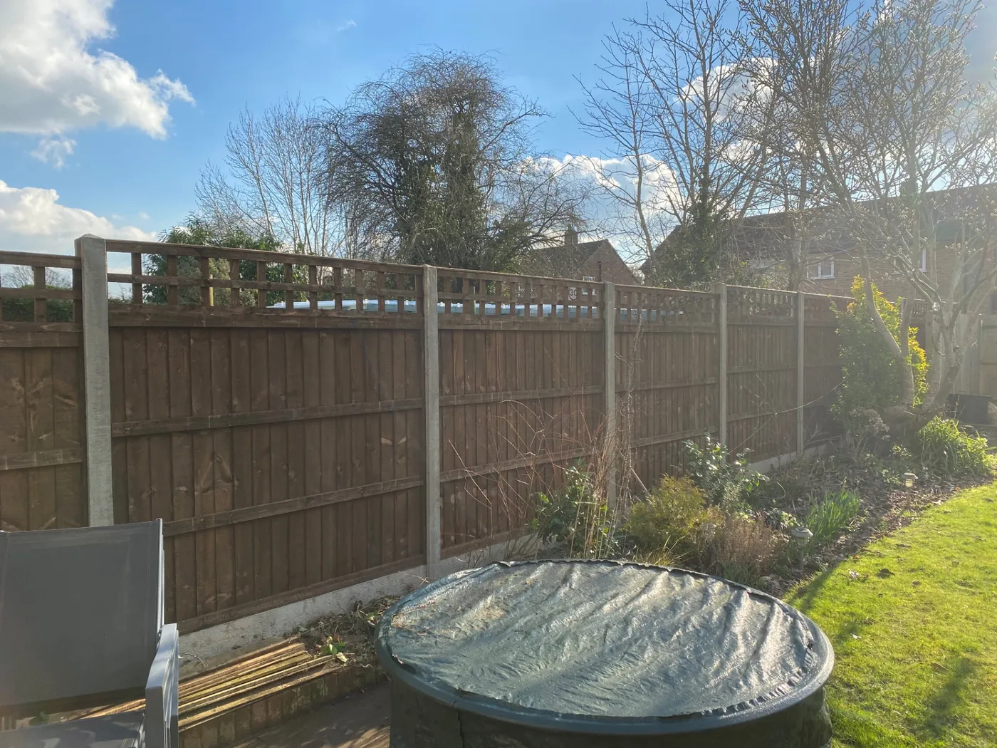 Trellis topped fence panels installed with concrete posts in a Farnham garden