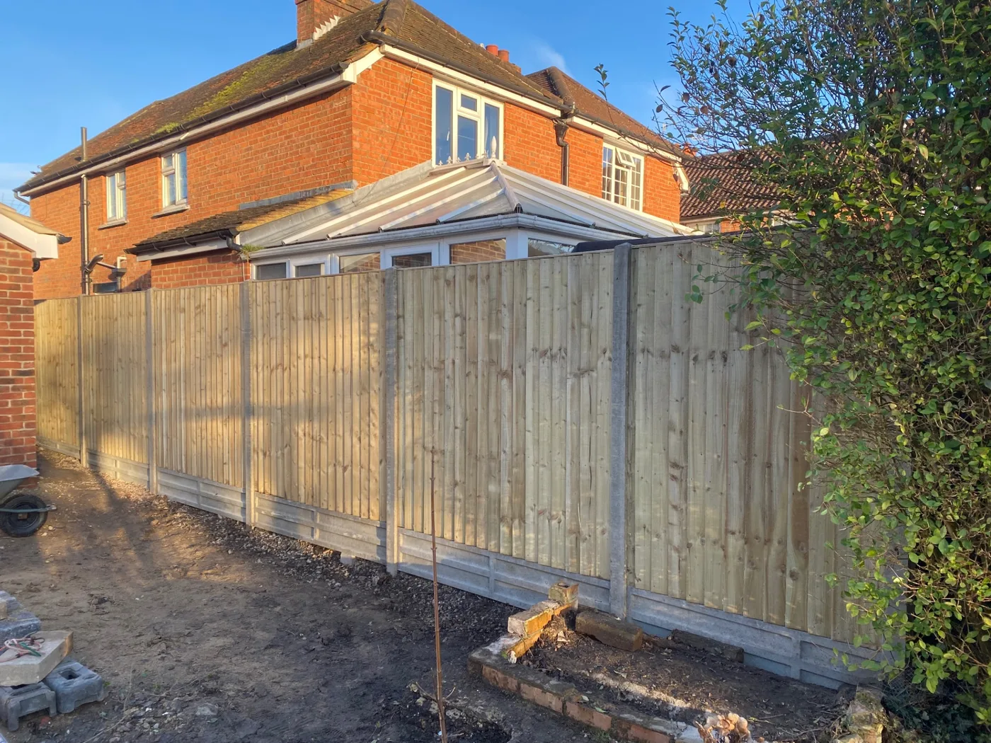 New feather edge fence panels with concrete posts and gravel boards